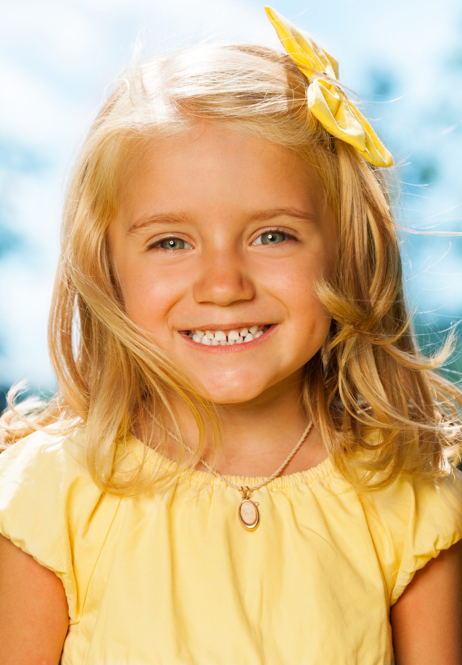 A smiling girl in yellow dress
